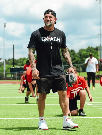 BCI coach on the field with young athletes